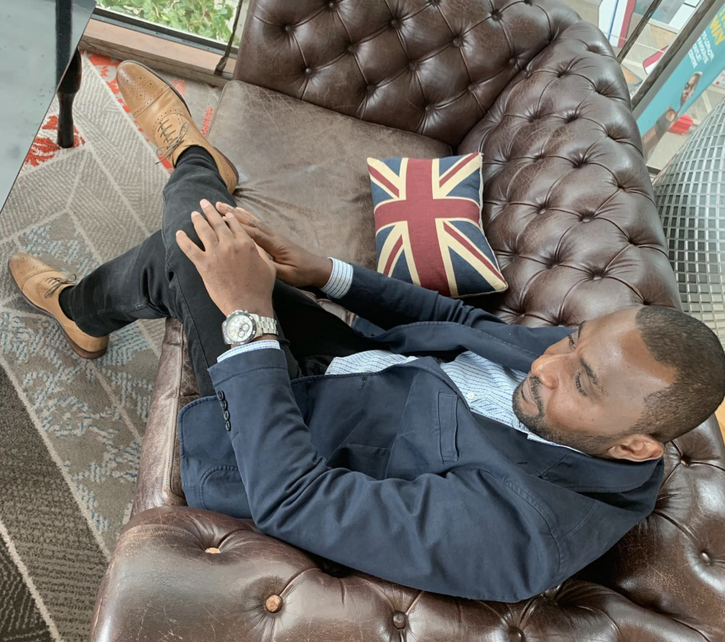 Robert, founder of 4DMC, seated in a leather armchair.