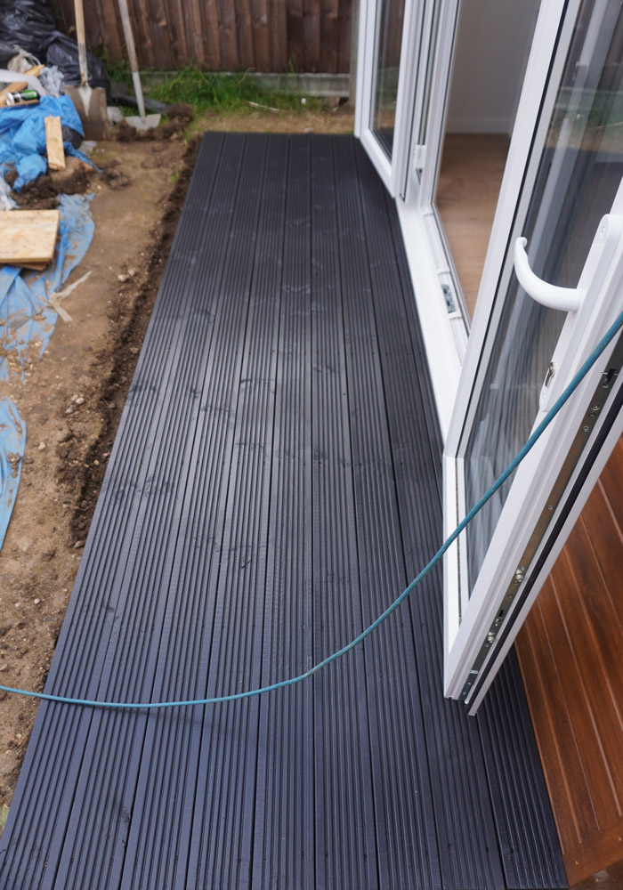 Completed dark decking along the side of the garden office