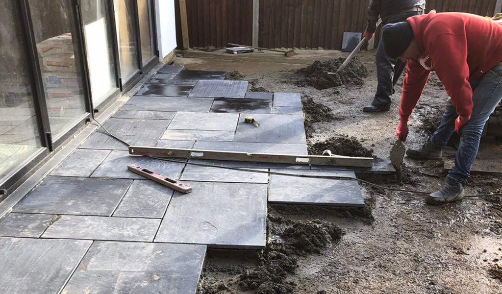 Paving being laid outside the glazed house extension